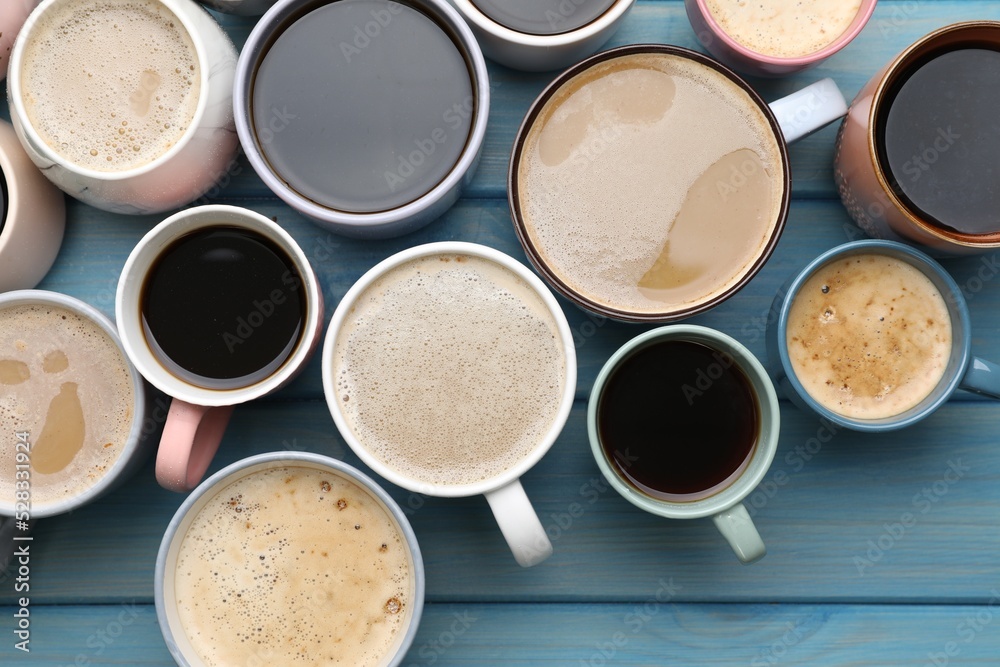 Many cups of different coffee drinks on light blue wooden table, flat lay Many cups of different coffee drinks on light blue wooden table, flat lay
