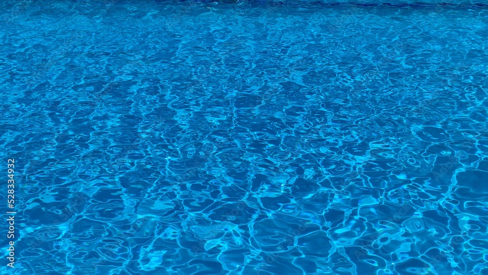 Shadows of clear blue water in a clean swimming pool