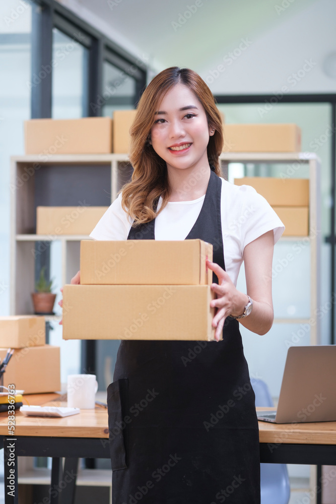 Young woman startup small business entrepreneur preparing parcel boxes of product for deliver to customer. Young woman startup small business entrepreneur preparing parcel boxes of product for deliver to customer.