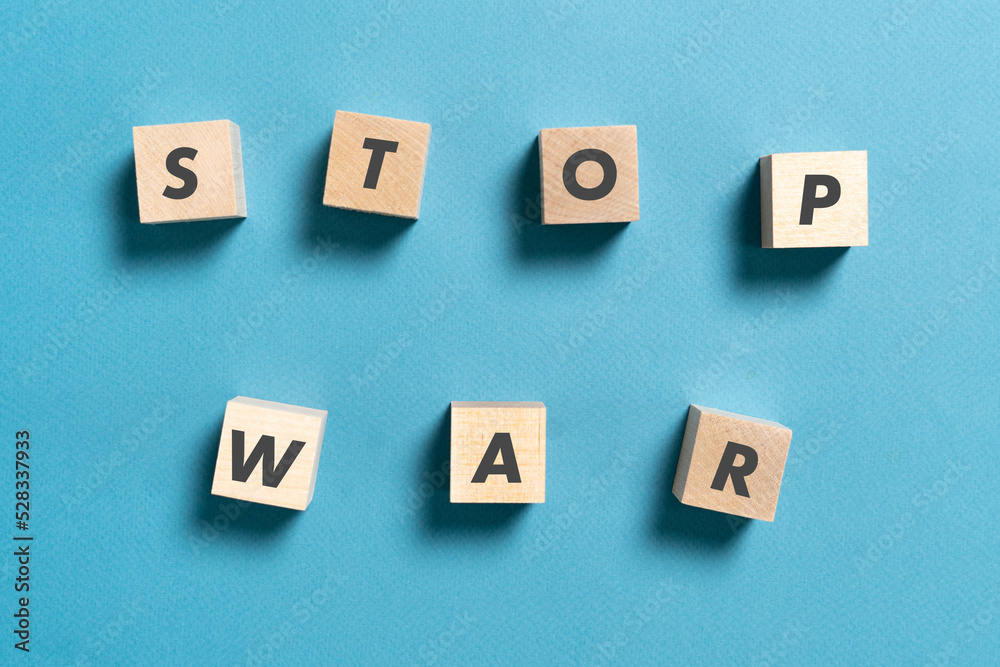 wooden cubes with stop war text on pastel background wooden cubes with stop war text on pastel background