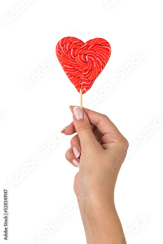 A woman's hand with a beautiful heart-shaped candy isolated on a white background.