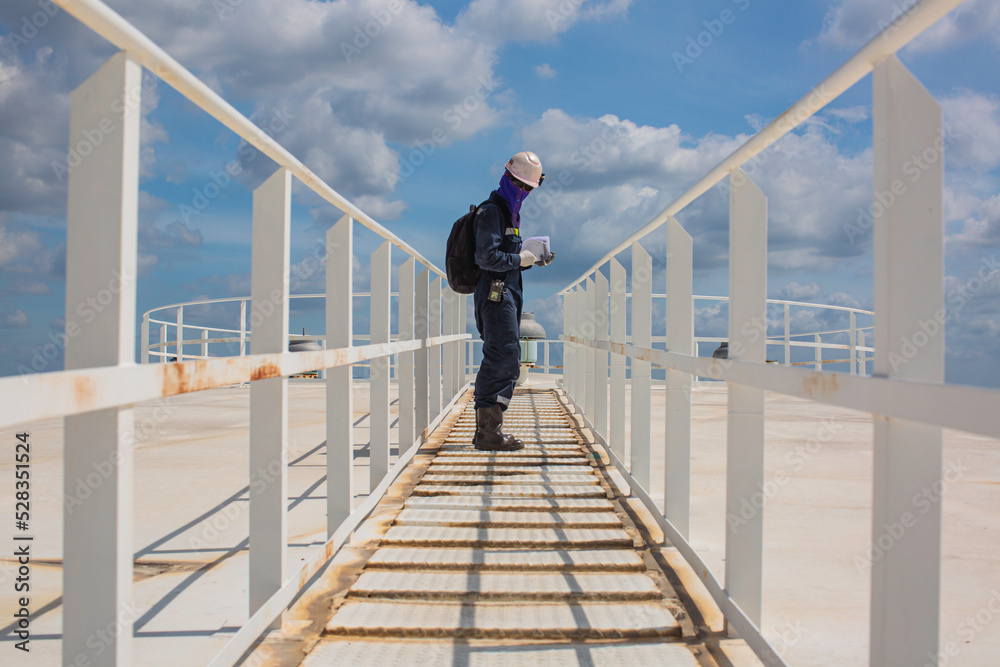 Male walking the up stairway inspection visual record stairs on the tank roof white Male walking the up stairway inspection visual record stairs on the tank roof white