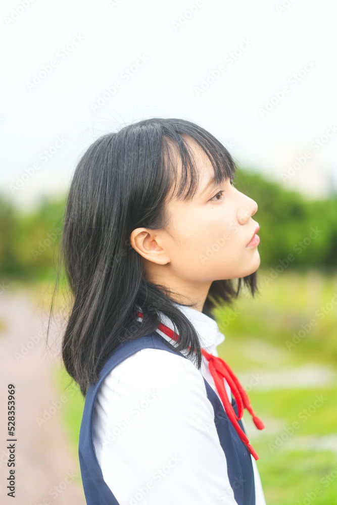 Portrait of cosplay side face woman short hair wear japanese student high school uniform at outdoor Portrait of cosplay side face woman short hair wear japanese student high school uniform at outdoor