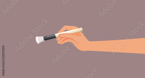 Hand Holding a Makeup Brush Vector Cartoon Illustration. Makeup artist working with professional tools 