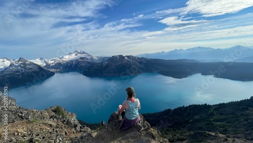 Woman hiker overlooking big glacier fed lake in Canada.  © Kezzia