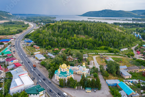 Drone view of Tsarev Kurgan and Rozhdestvenskaya church before summer thunderstorm. Volzhsky, Samara Oblast, Russia.