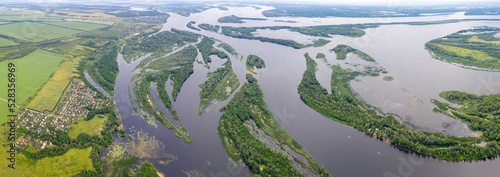 Panoramic aerial view of Volga river and Kommuna village on sunny summer day. Saratov Oblast, Russia. photo