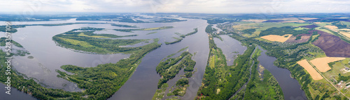 Panoramic aerial view of Volga river, Elshanka and Chardym villages on sunny summer day. Saratov Oblast, Russia.