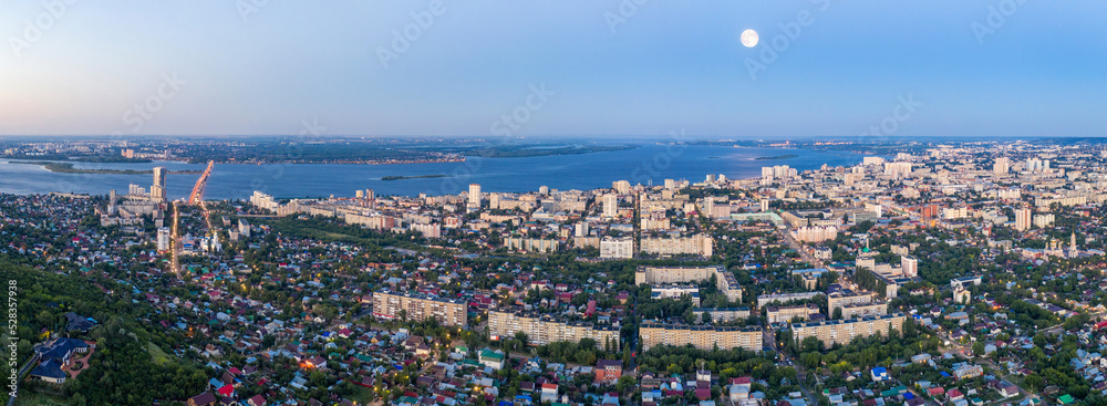 Panoramic aerial view of Saratov and and Volga River on morning blue hour. Saratov Oblast, Russia.