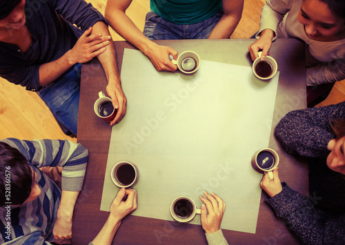 People sitting around table drinking coffee