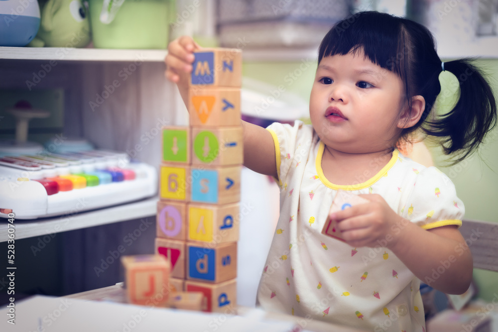 Asian Happy baby, toddler playing blocks or educational toys on the table. Cute baby learning, smiling and playing toy use as baby development and education concept. Asian Happy baby, toddler playing blocks or educational toys on the table. Cute baby learning, smiling and playing toy use as baby development and education concept.