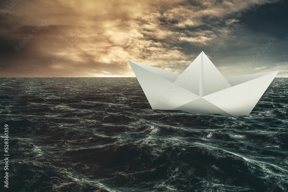 Fototapeta premium Paper boat floating on the sea