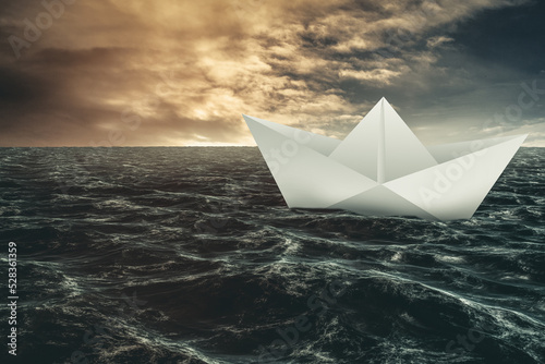 Paper boat floating on the sea