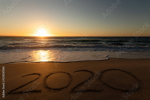 2020 on sand at sunset