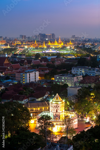 Ancient fortress tower with Grand Palace at Dusk (Bangkok, Thailand)