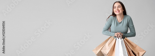 Happy young woman with shop...