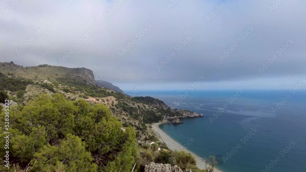 A cloudy sky over Playa del Pino beach in Andalusia. Looking down at the beach and the horizon in the southern part of Spain. Beautiful view over the beach and the Mediterranean sea. A cloudy sky over Playa del Pino beach in Andalusia. Looking down at the beach and the horizon in the southern part of Spain. Beautiful view over the beach and the Mediterranean sea.
