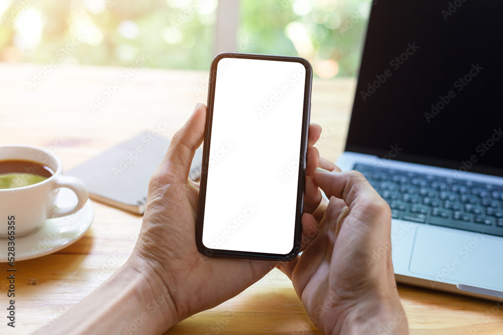 man hand using smartphone In the office Screen blank with clipping path ,Top view mockup image of male holding mobile phone with empty white screen man hand using smartphone In the office Screen blank with clipping path ,Top view mockup image of male holding mobile phone with empty white screen