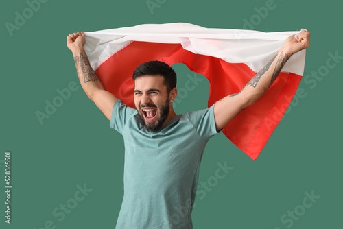 Happy young man with flag o...