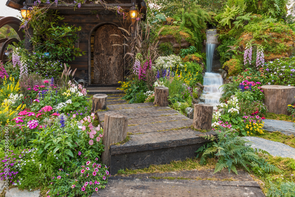 Landscaped backyard of old house with flower garden Landscaped backyard of old house with flower garden