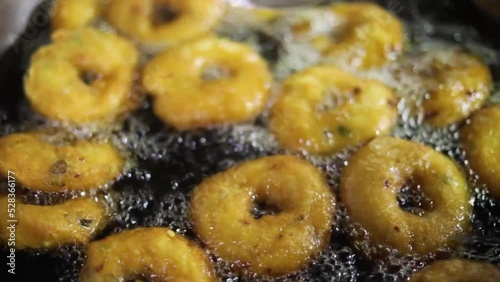 Uzhunnu vada or medu vada (uzhunnu vada is the malayalam name for medu vada) is a traditional Kerala style deep fried snack which is popularly served as a savory snack for evening Full HD Footage photo