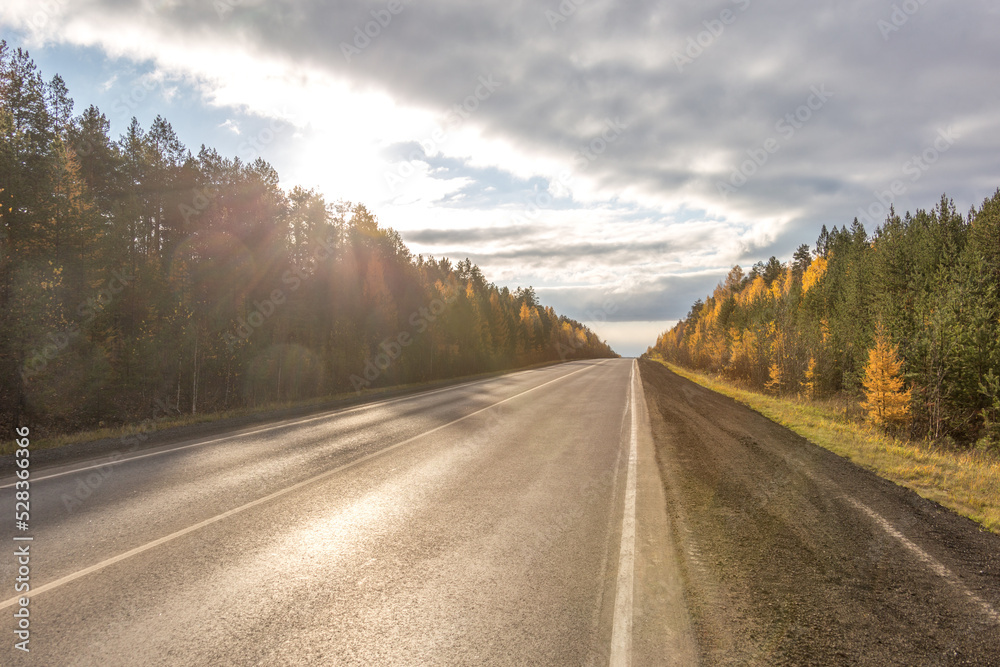 Beautiful autumn sunny road from Yekaterinburg to Nizhny Tagil (to Verkhoturye). Sverdlovsk region, Russia Beautiful autumn sunny road from Yekaterinburg to Nizhny Tagil (to Verkhoturye). Sverdlovsk region, Russia