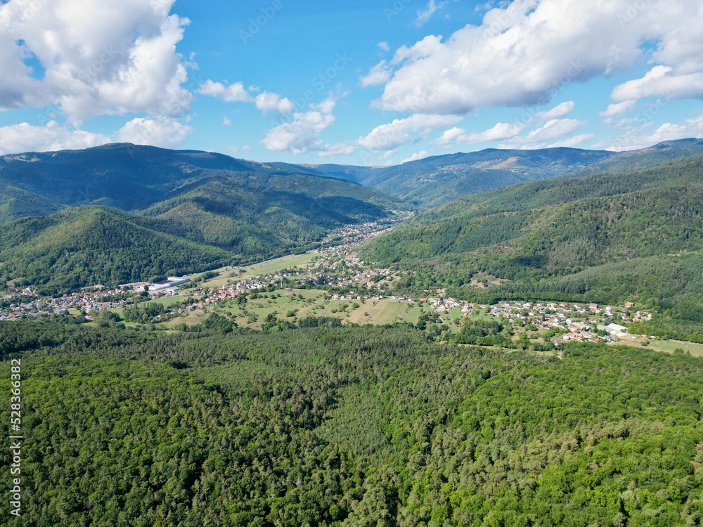 Panoramic aerial drone view of Lautenbach, Schweighouse and the Florival valley on a sunny summer day