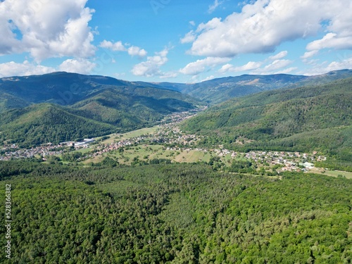 Fototapeta Naklejka Na Ścianę i Meble -  Panoramic aerial drone view of Lautenbach, Schweighouse and the Florival valley on a sunny summer day