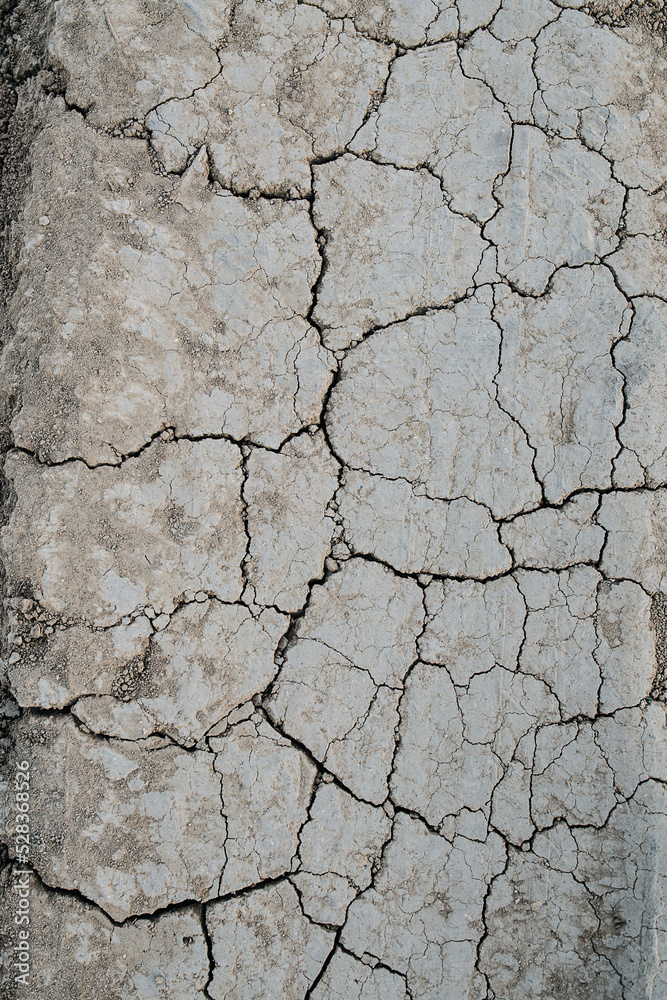 Tiles of cracked grey dry dirt texture. Top view Tiles of cracked grey dry dirt texture. Top view