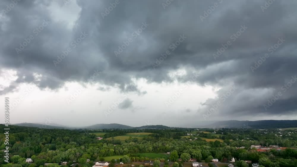An aerial view of a thunderstorm and giant rainstorm moving across the landscape. An aerial view of a thunderstorm and giant rainstorm moving across the landscape.