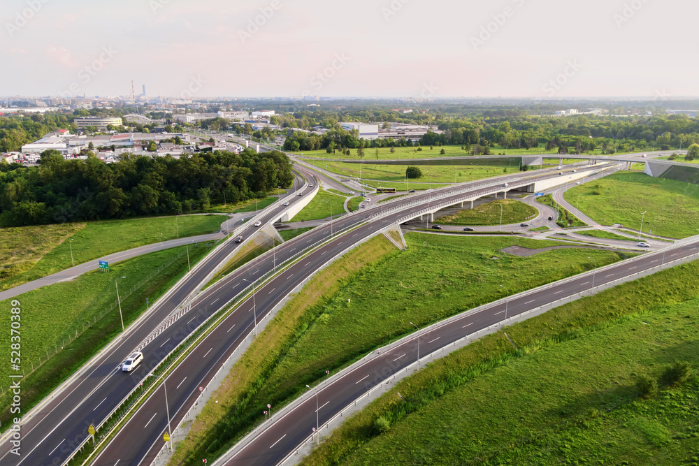 Aerial view of cars driving on round intersection in city, Transportation roundabout infrastructure, Highway road junction in Wroclaw, Poland
