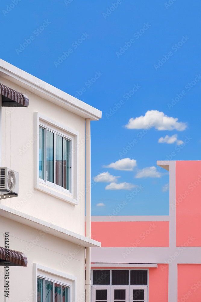Architecture background of external white and pink modern building against blue sky in perspective side view and vertical frame