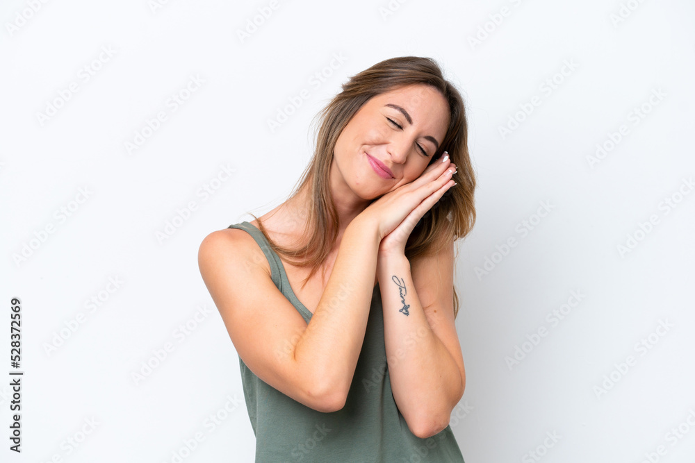 Young caucasian woman isolated on white background making sleep gesture in dorable expression Young caucasian woman isolated on white background making sleep gesture in dorable expression