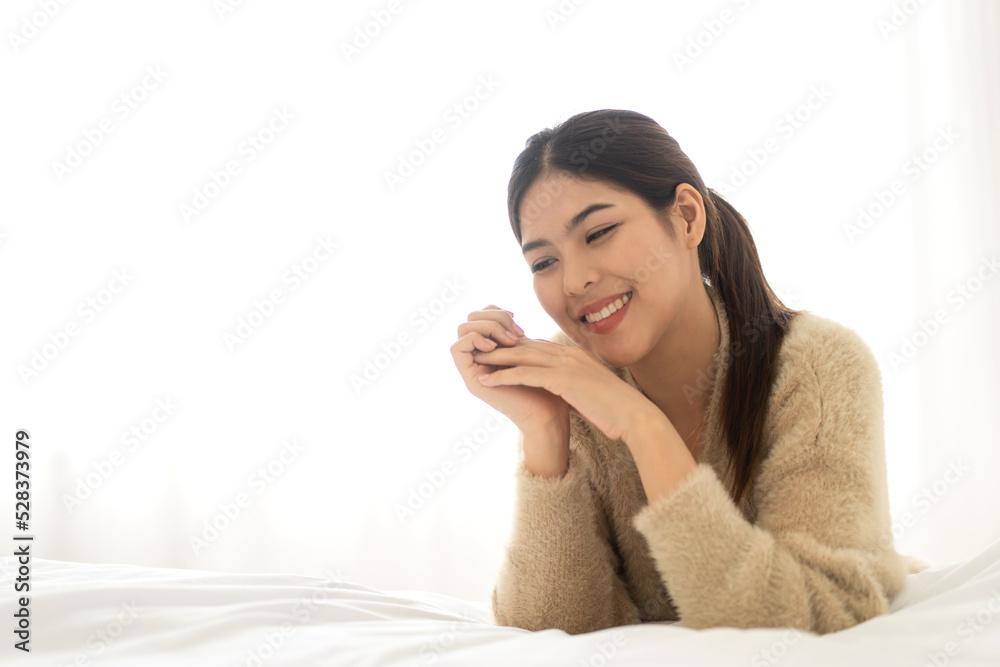 Portrait of smiling cheerful beautiful pretty asian woman clean fresh healthy white skin posing smile in pajamas clothes.Girl felling relax and enjoy time on the bed at home.asia beauty. Portrait of smiling cheerful beautiful pretty asian woman clean fresh healthy white skin posing smile in pajamas clothes.Girl felling relax and enjoy time on the bed at home.asia beauty.