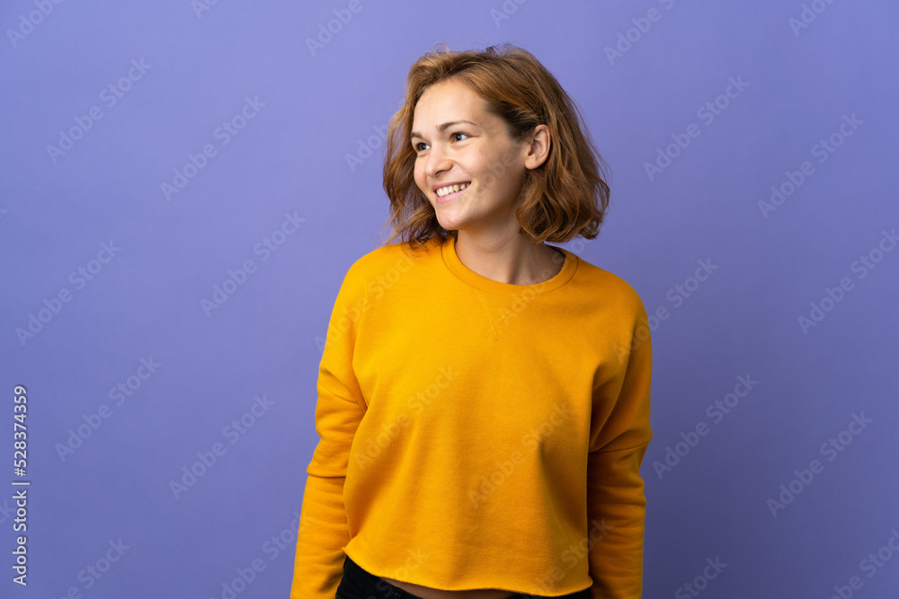 Young Georgian woman isolated on purple background looking side Young Georgian woman isolated on purple background looking side