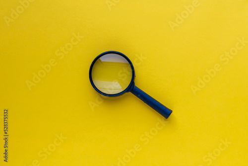 Magnifying glass isolated on orange background