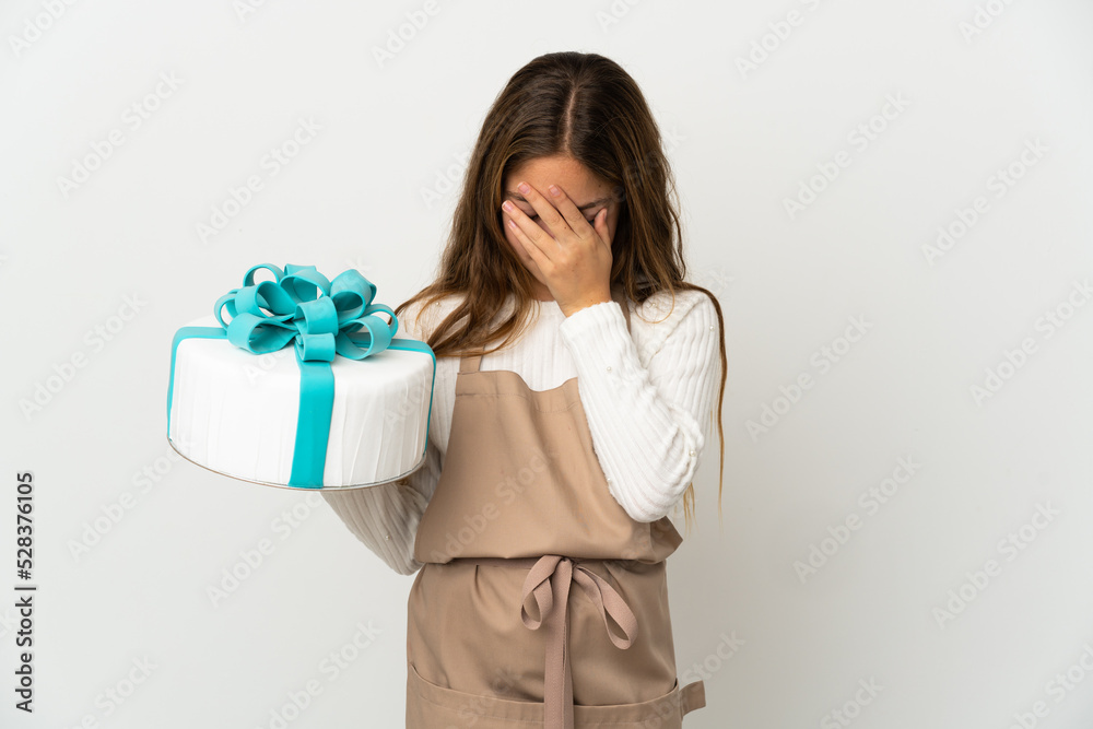 Little girl holding a big cake over isolated white background with tired and sick expression Little girl holding a big cake over isolated white background with tired and sick expression