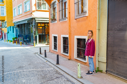 Young woman in pink jacket walking in Balat district in Istanbul © fotofabrika