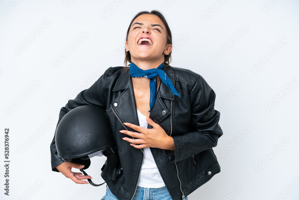 Young caucasian woman with a motorcycle helmet isolated on blue background smiling a lot Young caucasian woman with a motorcycle helmet isolated on blue background smiling a lot