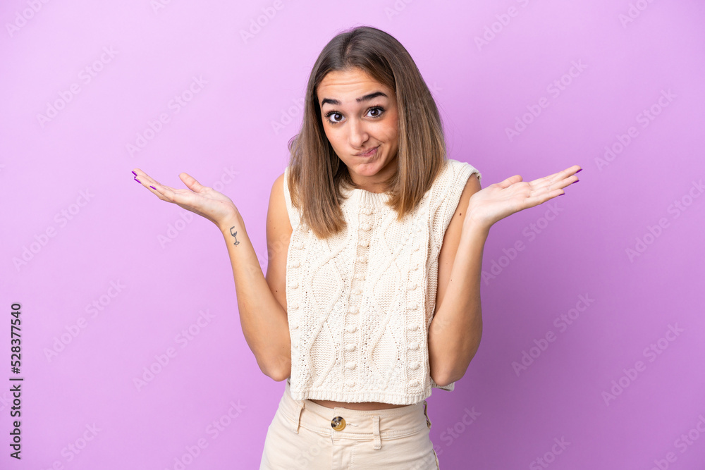 Young caucasian woman isolated on purple background having doubts while raising hands Young caucasian woman isolated on purple background having doubts while raising hands