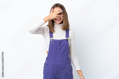 Young caucasian woman isolated on white background covering eyes by hands and smiling