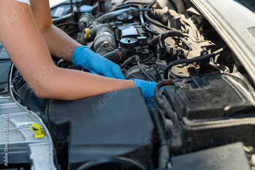 Close-up shot of a professional mechanic working on a vehicle in a car service.