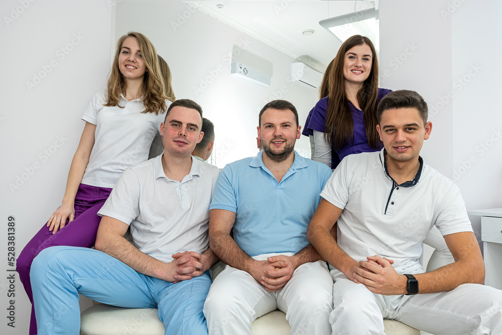 Beautiful young nice well-dressed dentists stand beautifully in their dental office. Beautiful young nice well-dressed dentists stand beautifully in their dental office.