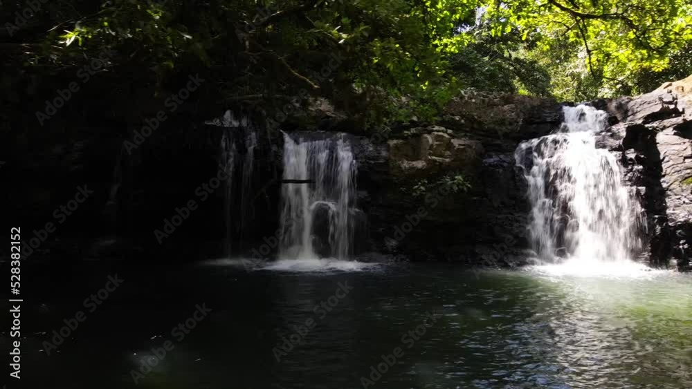 Slow aerial drone shot from left to right showcasing two waterfalls in a tropical forest, Costa Rica Slow aerial drone shot from left to right showcasing two waterfalls in a tropical forest, Costa Rica