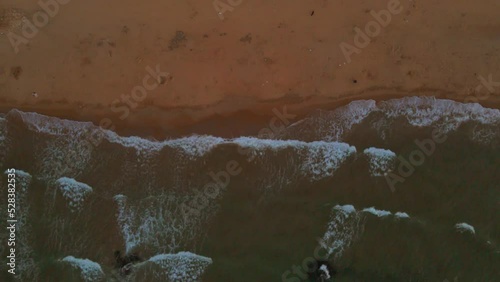 Aerial of foamy sea waves hitting the rocky beach of Kilyos in Istanbul photo