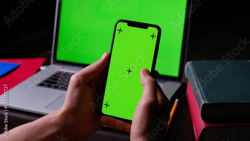 A man in the office works, chromakey. Phone in hand clicks on the screen