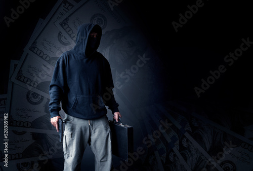 Double exposure thief or bandit man wearing black mask and holding gun on hand to make crime this a dangerous man with money background.