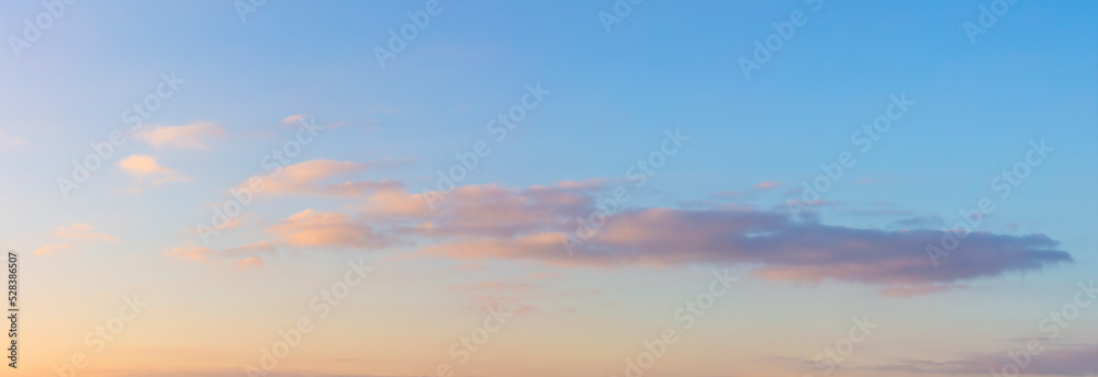 Soft gentle clouds in the morning sky. Soft haze and pastel colors of dawn.