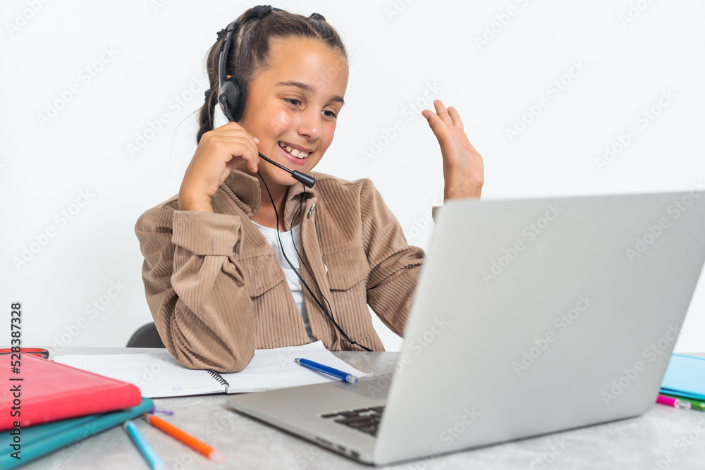 E-Learning. Shocked Little Schoolgirl Looking At Laptop Wearing Headphones Looking At Computer Web Camera In Shock Making Video Call And Learning Online At Home. Shocking News Concept. E-Learning. Shocked Little Schoolgirl Looking At Laptop Wearing Headphones Looking At Computer Web Camera In Shock Making Video Call And Learning Online At Home. Shocking News Concept.