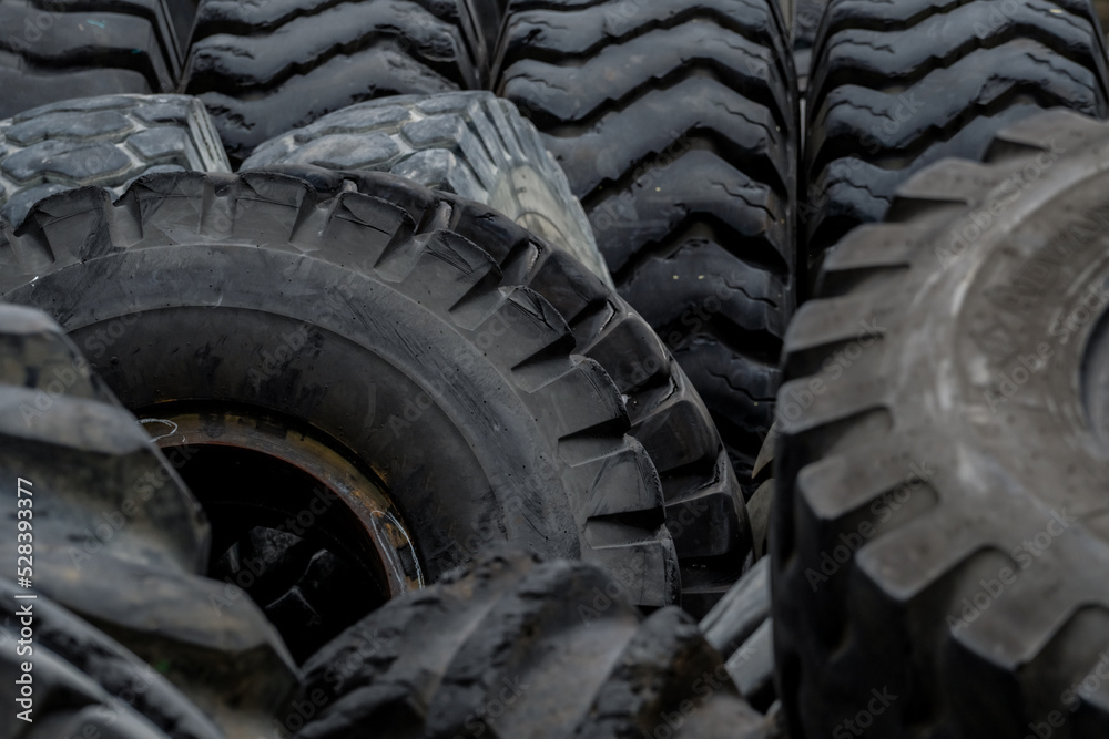 Closeup used truck tires. Old tyres waste for recycle or for landfill. Black rubber tire of truck. Pile of used tires at recycling yard. Material for landfill. Recycled tires. disposal waste tires. Closeup used truck tires. Old tyres waste for recycle or for landfill. Black rubber tire of truck. Pile of used tires at recycling yard. Material for landfill. Recycled tires. disposal waste tires.